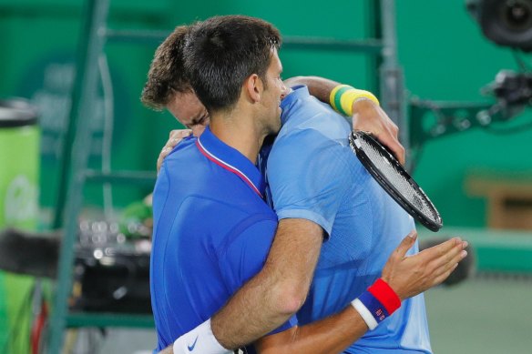 Juan Martin del Potro cries while hugging Novak Djokovic after defeating him. 