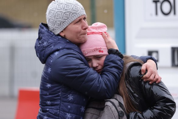 A mother and daughter wait to flee war-torn Ukraine into Poland this week.