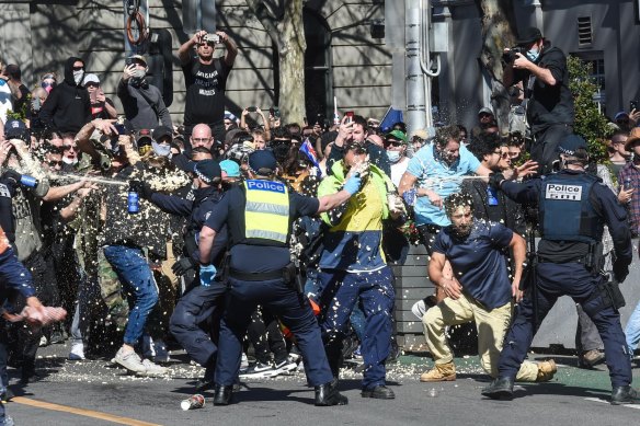 Anti-lockdown protestors clash with police on Spring st near Parliament House last September.
Protesters break through a Police lines after being pepper spayed.