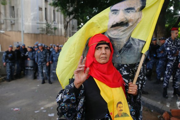 A Kurdish demonstrator holds a flag of jailed Kurdish leader Abdullah Ocalan in 2018.