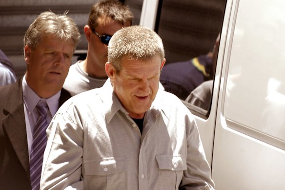 Bradley John Murdoch is led through the compound at the back of the Adelaide Magistrates court on November 13, 2003.