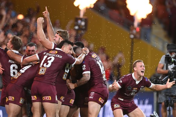 The Maroons celebrate after the siren.