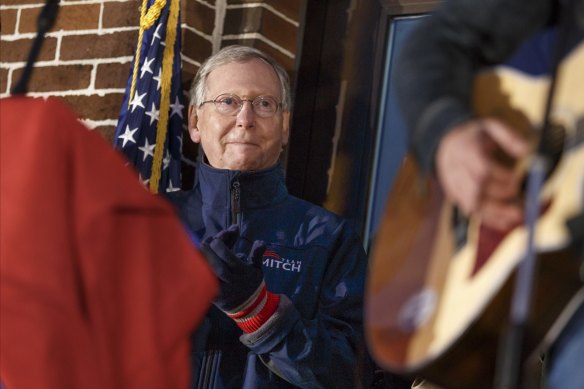Mitch McConnell listens to singer Jimmy Rose perform "Coal Keeps the Lights On" in his coal-mining home state of Kentucky in 2014.