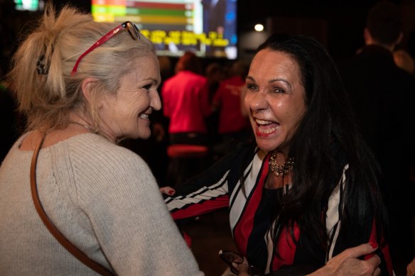 Linda Burney greets Labor Party supporters as they watch the election count on Saturday night.