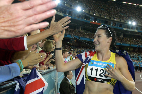 Australia’s Jana Pittman celebrates with spectators during her victory lap after winning the gold medal in the Women’s 400 metres hurdles during the Commonwealth Games in Melbourne.