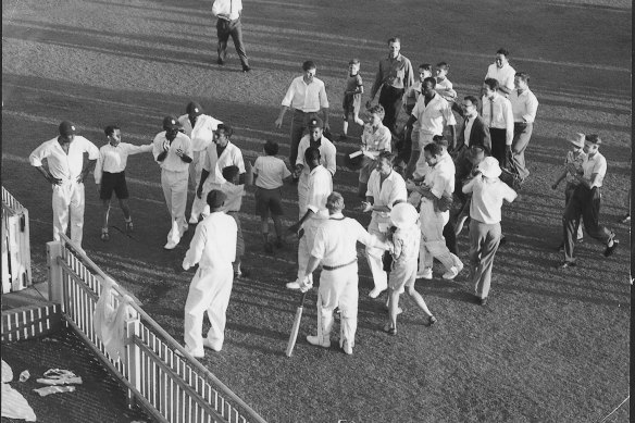 Players move to the gate leading to the dressing pavilion after the Tied Test at the Gabba.  