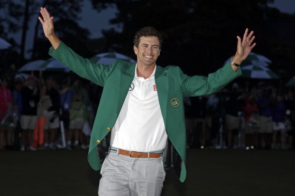 Adam Scott shows off his green jacket after winning the Masters golf tournament in 2013.