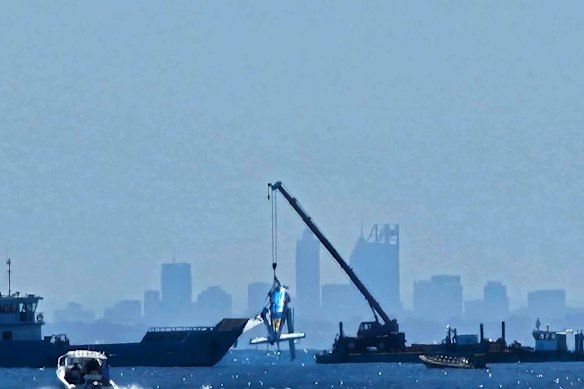 The seaplane being retrieved from the ocean floor.