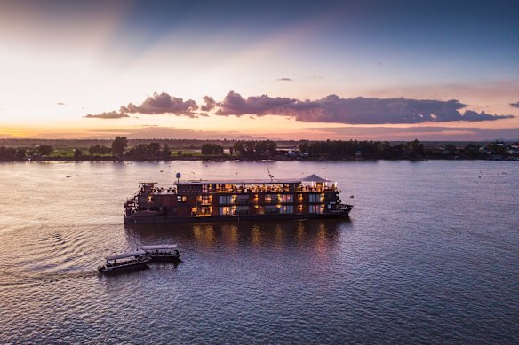 Auxiliary launch boats approach the river cruise ship Aqua Mekong on the Tonle Sap river, Cambodia.
