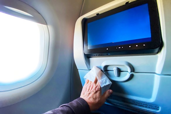 Antibacterial wipes can help remove germs from your tray table.