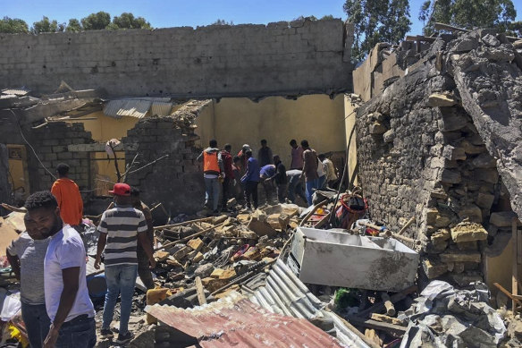 Residents sift through rubble from a destroyed building at the scene of an airstrike in Mekele, in the Tigray region of northern Ethiopia, in late October.