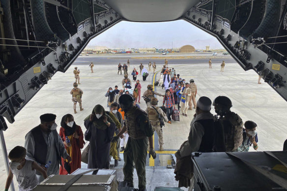 Refugees board a Spanish air force plane during the evacuation of Kabul.
