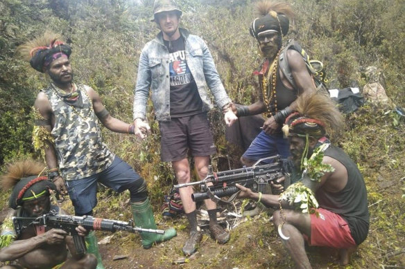 Papuan separatist rebels pose with New Zealander pilot Phillip Mark Mehrtens who they took hostage last week, at an undisclosed location in Papua province, Indonesia. 