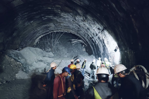 Rescuers inside a collapsed road tunnel where workers were trapped by a landslide in northern in Uttarakhand state, India.