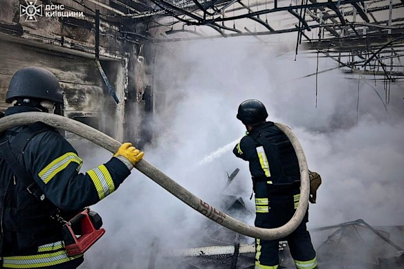 In this photo provided by the Ukrainian Emergency Service, firefighters put out the fire following Russia’s drone attack in the Kyiv region on Sunday.