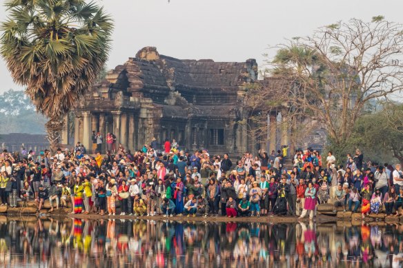 Join the crush for a disappointing sunrise at Angkor Wat.