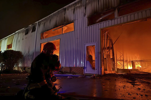 Emergency service personnel try to extinguish a fire following a Russian attack in Odesa.