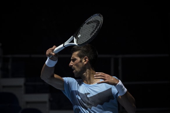 That was then, this is now: Serbian tennis player Novak Djokovic, still unvaccinated, trains on Friday for the 2023 Australian Open. This time last year Australia expelled him. 