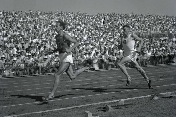 John Landy leads Merv Lincoln in the third lap of the mile race where he managed another time below four minutes at Olympic Park.