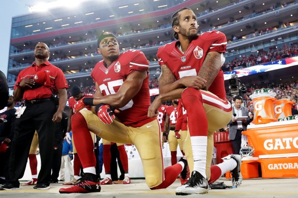 Colin Kaepernick, right, and Eric Reid take a knee during the US national anthem in 2016.
