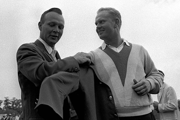 Green machine: Arnold Palmer (left) helps Jack Nicklaus into another green jacket after Nicklaus' nine-stroke victory at the Masters in 1965.
