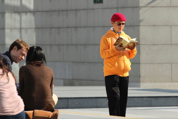 Xiao Jianhua, a Chinese-born Canadian billionaire, reads a book outside the International Finance Centre in Hong Kong.
