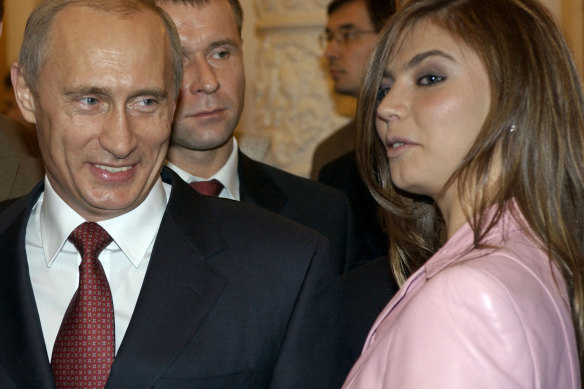 Russian President Vladimir Putin, left, speaks with gymnast Alina Kabaeva as he hosts Russia’s Olympic athletes at a Kremlin banquet in Moscow in 2004.