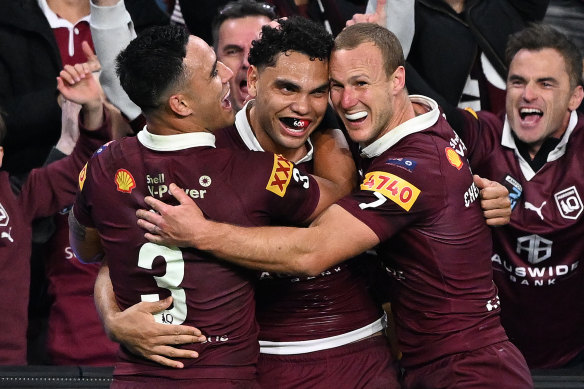 Valentine Holmes, Xavier Coates and Daly Cherr-Evans celebrate after their series win.