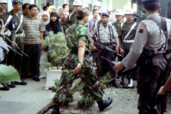 An Indonesian soldier convicted of murder, centre, leaves court in 2000, after a landmark human rights tribunal convicted 24 soldiers and one civilian of massacring 57 villagers during an anti-rebel operation in Banda Aceh the year before.