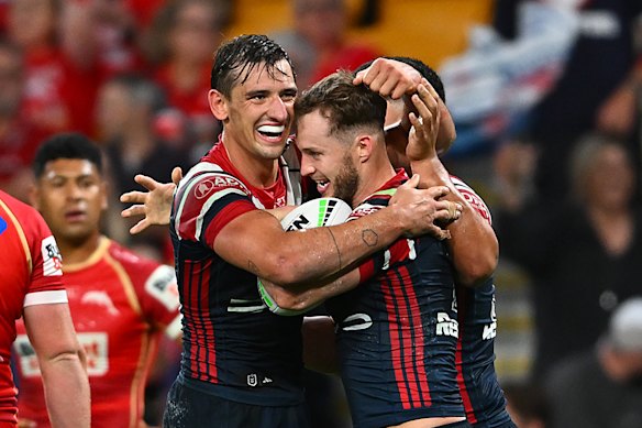 Sam Walker gets a cuddle from Billy Smith during his excellent comeback game from injury.