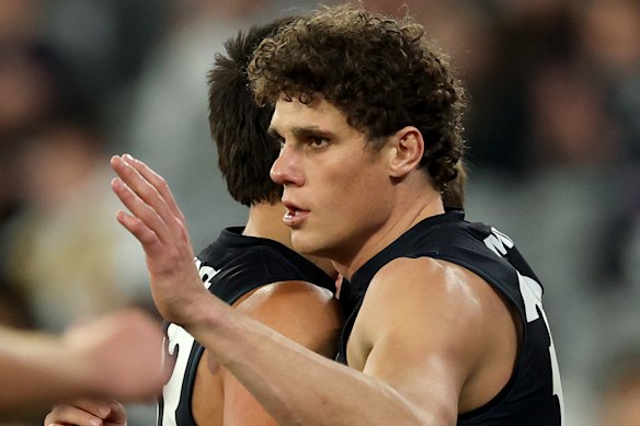 Charlie Curnow of the Blues is congratulated by Ashton Moir after kicking a goal.