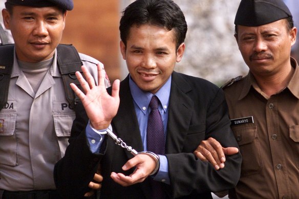 Ali Imron waving to journalists after his sentencing in 2003. He was spared the death penalty because of his remorse and co-operation with authorities. 