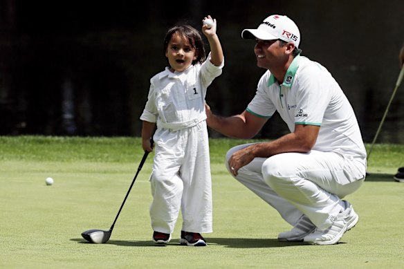Jason Day with son Dash during the par three contest at the Masters in 2015.