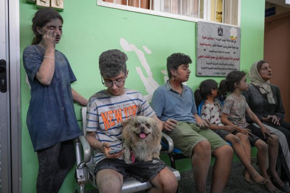 Injured civilians wait for treatment following Israeli airstrikes in the Rimal district of Gaza City.