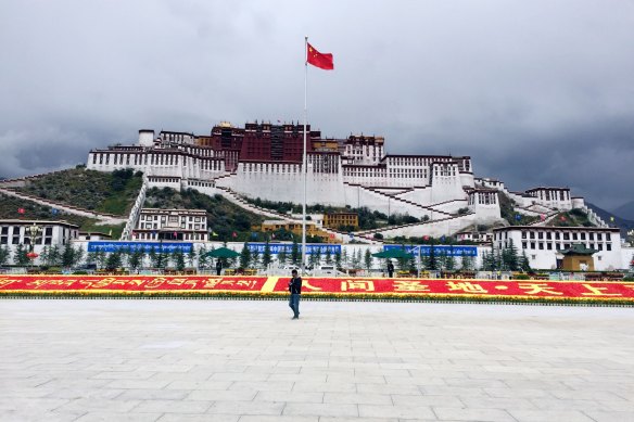 The Chinese flag flies over the Potala Palace in Lhasa, Tibet. 