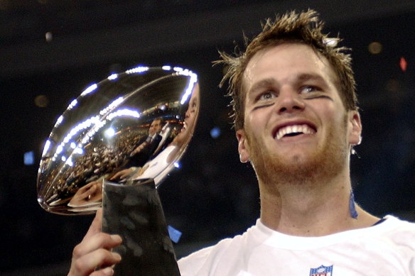 The Vince Lombardi Trophy is awarded to the team that wins the Super Bowl each year. Tom Brady, pictured here, has won seven titles.