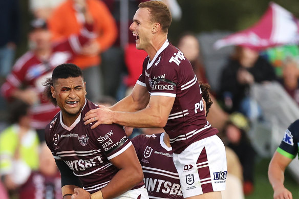Daly Cherry-Evans clambers on the back of Haumole Olakau’atu in the Mudgee game against the Raiders.