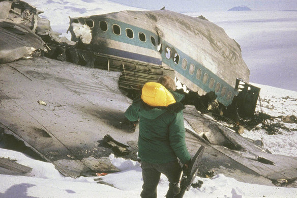 A rescue worker walks past the wreckage of an Air New Zealand DC10 plane.