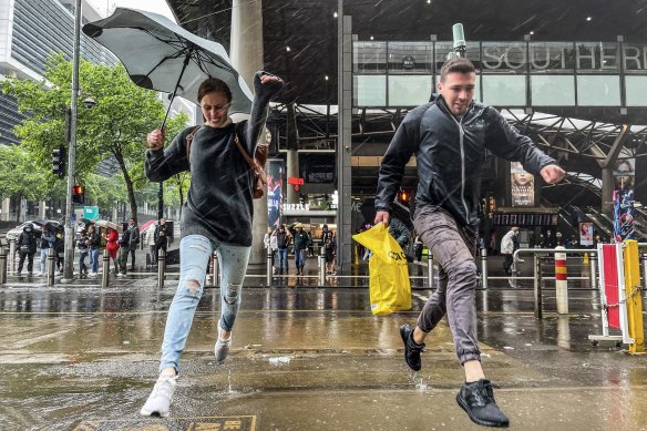 Caroline Grunewald and Keegan Marsh were caught in a sudden downpour in the CBD on November 14.