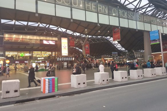 At Southern Cross Station, a temporary safety bollard is treated to some guerilla art.