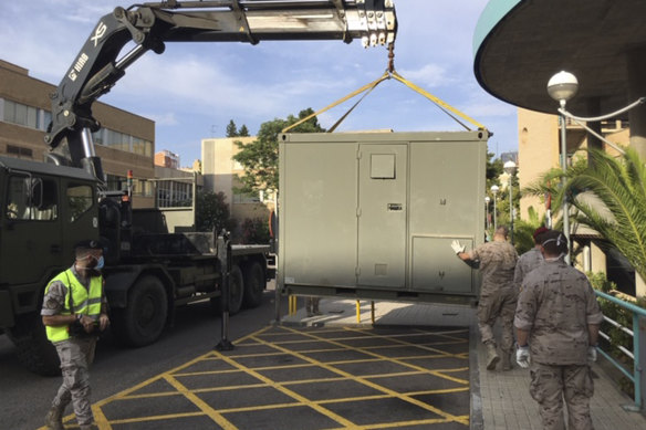 Soldiers set up a temporary ward in the car park of a hospital in Zaragoza.