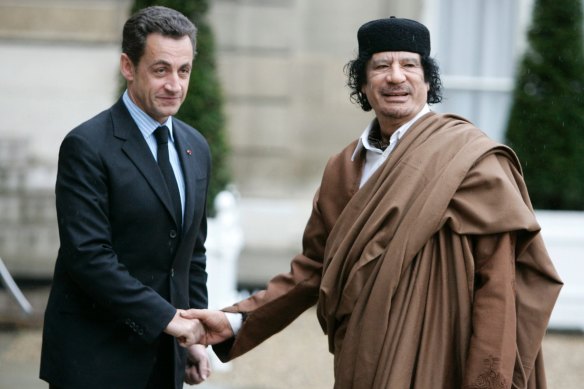 In this December 2007 file photo, French President Nicolas Sarkozy, left, greets Libyan leader Col. Moammar Gadhafi upon his arrival at the Elysee Palace, in Paris. 