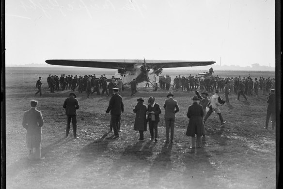 A crowd waits to meet Charles Kingsford Smith in the Southern Cross after flying across the Pacific.