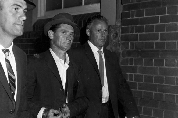 Melbourne prison escapee Ronald Ryan being taken to police headquarters in Sydney after his recapture on January 5, 1966.