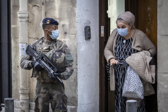 French soldiers, part of France's national security alert system 'Sentinelle', patrol around the Great Synagogue in Marseille. 