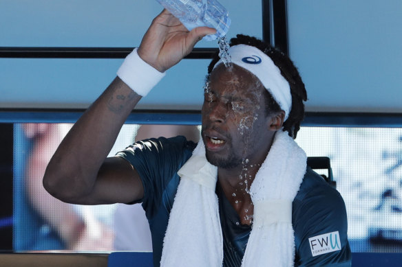 France's Gael Monfils douses himself with water due to the searing heat on court during the Australian Open in Melbourne in 2018.
