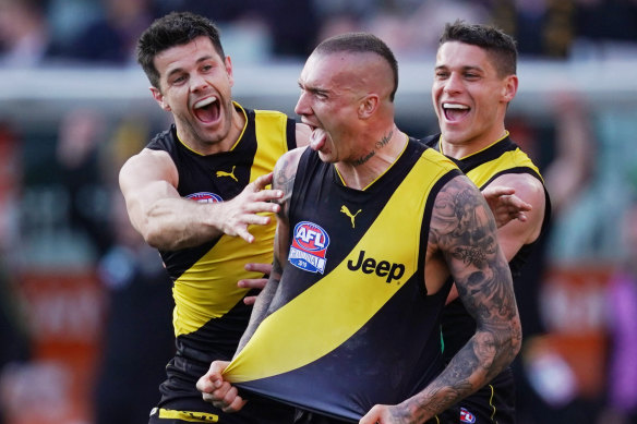 Trent Cotchin, Dustin Martin and Dion Prestia celebrate a goal.