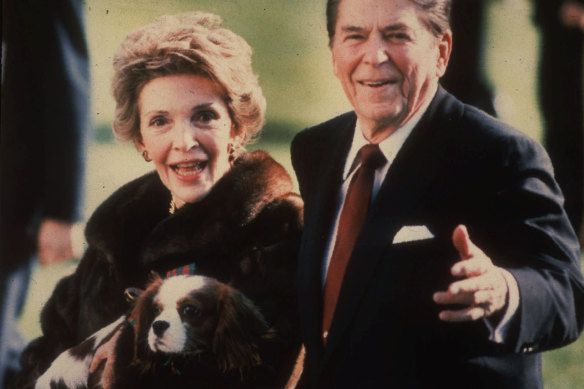 First lady Nancy Reagan holds the Reagans' pet Rex, a King Charles spaniel, on the White House South lawn. 