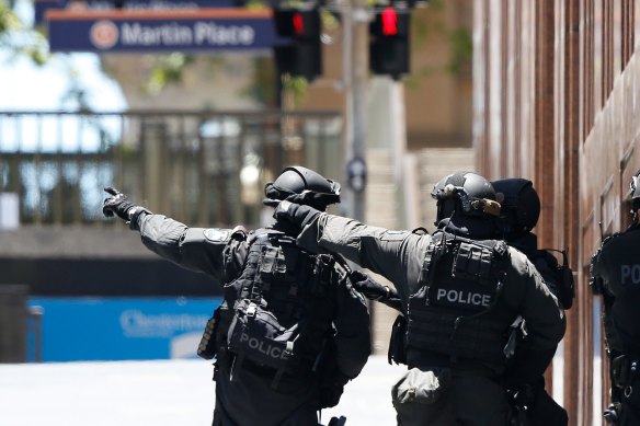 Police outside the cafe during the siege. 