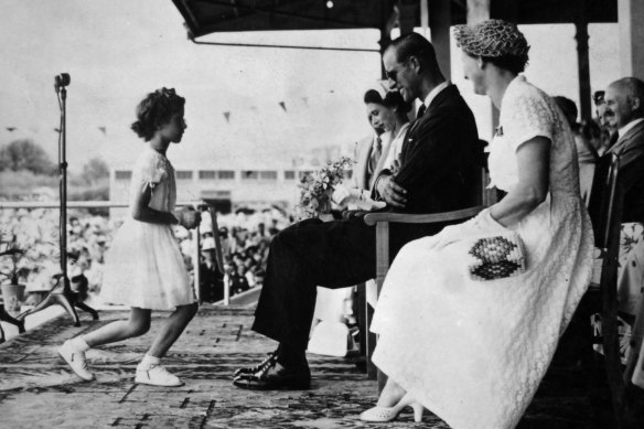 Seven year old Cheryl Fulton curtsies before the Queen and Duke of Edinburgh at Cairns Showground in 1954.